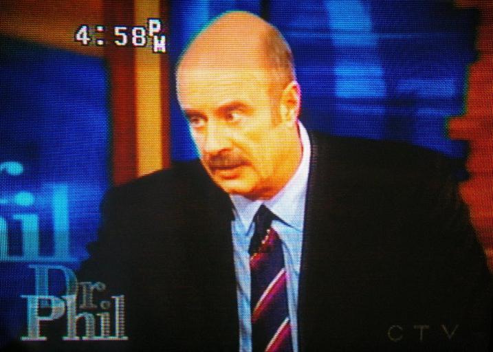 retro filtered image of dr. phil looking suspiciously to his right